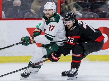 Ottawa Senators defenceman Thomas Chabot, playing his 300th career NHL game, checks the Minnesota Wild's Marcus Foligno during the second period at the Canadian Tire Centre on Tuesday, Feb. 22, 2022.