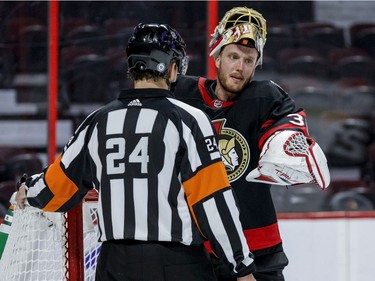 Ottawa Senators goaltender Anton Forsberg (31) talks with referee Graham Skiliter (24) during a stoppage in play.