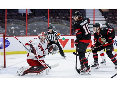 Ottawa Senators left wing Alex Formenton (10) and right wing Connor Brown (28) watch the puck ring off the crossbar behind Carolina Hurricanes goaltender Antti Raanta (32) during the first period.