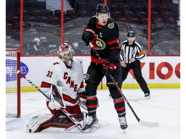 Ottawa Senators left wing Brady Tkachuk (7) looks to deflect a shot in front of Carolina Hurricanes goaltender Antti Raanta.