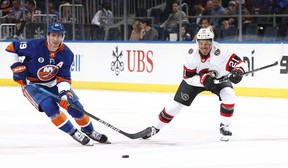 Mathieu Joseph, making his Ottawa Senators debut, and Brock Nelson of the New York Islanders chase the puck during the first period at UBS Arena on March 22, 2022 in Elmont, N.Y.