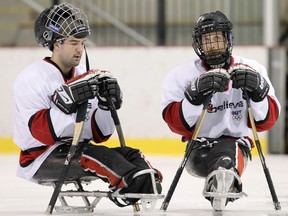 Greg Westlake (L) and Shawn Matheson (R), of Canada’s National Sledge Team, take a break, during a practice, held at the Bell Sensplex, in Ottawa, ON, on February 02, 2010.