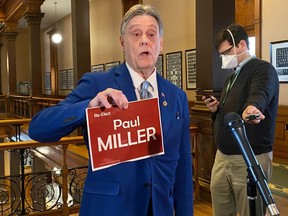 Paul Miller, an ousted member of the Ontario New Democrats, shows his Independent campaign sign at Queen's Park in Toronto on March 23, 2022.
