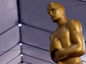 An Oscar statue sits before being placed out for display as preparations for the Academy Awards are underway in Los Angeles March 24, 2022.