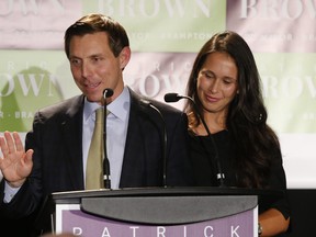 Patrick Brown, flanked with his wife Genevieve, is ushered in as the new mayor of Brampton, in this Oct. 22, 2018 file photo.