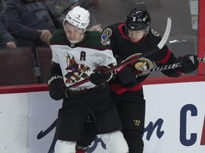 Ottawa Senators defenceman Nick Holden collides with Arizona Coyotes right wing Clayton Keller along the boards last night at Canadian Tire Centre.  Adrian Wyld/THE CANADIAN PRESS