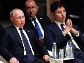 Russian President Vladimir Putin, left, and Prime Minister Justin Trudeau attend the opening ceremony of the Paris Peace Forum at the Villette Conference Hall in Paris on Nov. 11, 2018.