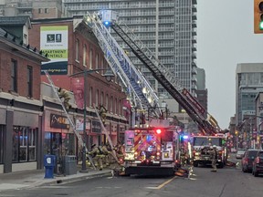 Ottawa firefighters battle a fire in a business on Bank Street, between Nepean and Lisgar streets, on Sunday, March 27, 2022.