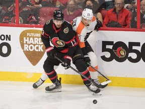 Senators left-winger Zach Sanford (13) battles with Flyers left-winger James van Riemsdyk for puck possession in the third period.