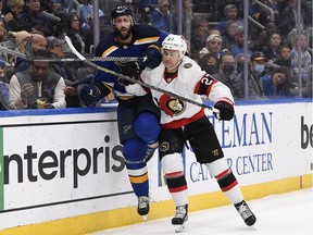 Ottawa Senator Dylan Gambrell checks St. Louis Blues defenseman Robert Bortuzzo in the first period at Enterprise Center.