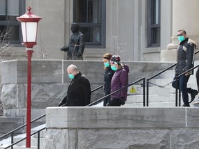 A group of individuals wearing masks walk on the University of Ottawa campus on Wednesday.
