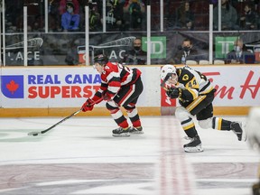 67's forward Vinzenz Rohrer gains control of the puck and pulls ahead of the Bulldogs' Nathan Staios while killing a penalty in the first period of Saturday's game.