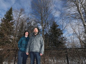 Blair Jackson and his son, Rylan, stand in front of the woods behind their house. The Ottawa-Carleton District School Board plans to cut down most of this small slice of forest to make room for more play area.