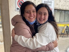 Serene Summers, left, hugs her best friend Eva Salinas, outside CHEO on Tuesday. Eva was with Serene when she was struck by a hit-and-run driver on Feb. 13.