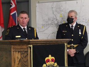 Timmins Police Insp. Darren Dinel speaks, as Chief Daniel Foy looks on, at a news conference held Friday, March 11, 2022, to announce the arrest of a Toronto man in connection with a triple shooting in September, 2021, that claimed the life of a Timmins man.