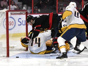 Ottawa Senators left winger Brady Tkachuk crashes into Nashville Predators goaltender Juuse Saros.