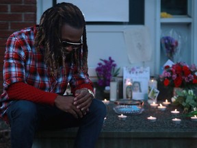 About 20 people gathered in front of Marie Gabriel's home on Friday night to remember the young mother of two who was found dead there on March 28. Her brother, David Gabriel|, left, and boyfriend Jean Hilaire Isralon were among those who lit candles.