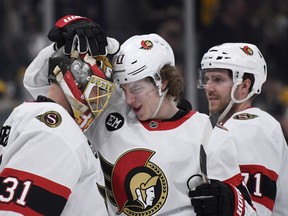 Ottawa Senators centre Adam Gaudette (17) congratulates goaltender Anton Forsberg (31) after defeating the Boston Bruins at TD Garden.
