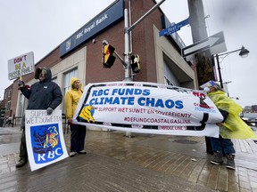 Extinction Rebellion Ottawa protestors Eric Schiller, Linda McCourt, and Cecile Wilson, at a RBC branch on Bank Street on Thursday, Apr. 7, 2022