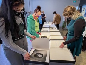 People view works of art at the School of the Photographic Arts: Ottawa as part of SPAO Diploma Exhibition No. 17, which runs from April 22 through May 15.