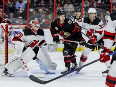 Ottawa Senators centre Josh Norris (9) battles New Jersey Devils defenceman Ryan Graves (33) in front of goaltender Mackenzie Blackwood (29) in the first period at the Canadian Tire Centre on April 26,2022.