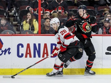 Ottawa Senators left wing Brady Tkachuk (7) battles New Jersey Devils defenceman Damon Severson (28) in the first period at the Canadian Tire Centre on April 26, 2022.