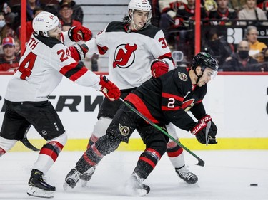 Ottawa Senators defenceman Artem Zub (2) battles New Jersey Devils defencemen Ty Smith (24) and Ryan Graves (33) in the first period at the Canadian Tire Centre on April 26, 2022.