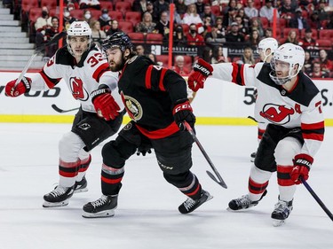 Ottawa Senator Mark Kastelic (47) is slowed down by two Devils in the first period at the Canadian Tire Centre on April 26, 2022.