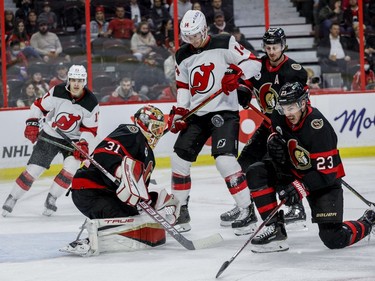 Ottawa Senators defenceman Travis Hamonic (23) and goaltender Anton Forsberg (31) defend against the New Jersey Devils in the second period on Tuesday night at the Canadian Tire Centre.
