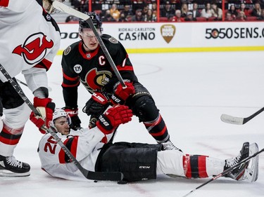 Ottawa Senators left wing Brady Tkachuk (7) takes down New Jersey Devils centre Michael McLeod (20) after a faceoff in the third period.