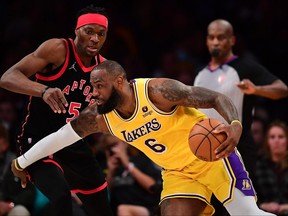 Lakers forward LeBron James moves to the basket against Toronto Raptors forward Precious Achiuwa, April 16, 2022