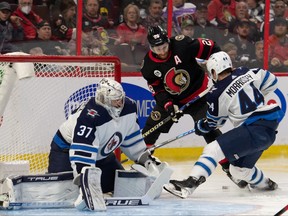 Winnipeg Jets defenceman Josh Morrissey (44) battles with Ottawa Senators right wing Connor Brown (28) in the second period at the Canadian Tire Centre.