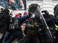 Riot police push back a crowd of supporters of U.S. President Donald Trump after they stormed the Capitol building in Washington, D.C., Jan. 6, 2021.