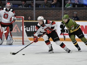 67’s defenceman Jack Matier heads up the ice past North Bay’s Michael Podolioukh in the playoff opener last night in North Bay.