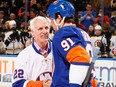 In this 2015 photo, former New York Islander Mike Bossy greets John Tavares prior to the game during Mike Bossy Tribute Night at the Nassau Veterans Memorial Coliseum in Uniondale, New York.