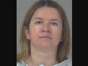 Mugshot of woman who killed eight-year-old son over Russia's war on Ukraine.