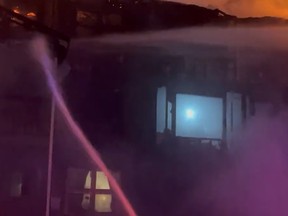 The flashlights visible are Ottawa Fire Firefighters searching for occupants during a fire at a multi-residential building on Ogilvie Road.