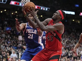 Toronto Raptors forward Pascal Siakam (43) controls the ball against Philadelphia 76ers center Joel Embiid (21) during the second half at Scotiabank Arena, April 7, 2022.