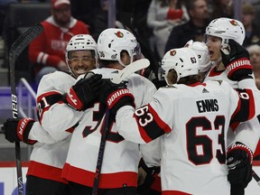Senators winger Mathieu Joseph, far left, celebrates with Senators teammates in the third period after scoring one of his three goals against the Detroit Red Wings on Friday, April 1, 2022.