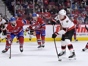 Ottawa Senators forward Brady Tkachuk (7) shoots the puck against Montreal Canadiens defenseman Joel Edmundson (44) during the third period at the Bell Centre, March 19, 2022.