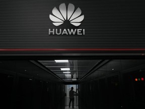 A technician stands at the entrance to a Huawei 5G data server center at the Guangdong Second Provincial General Hospital in Guangzhou, in southern China's Guangdong province, Sept. 26, 2021.