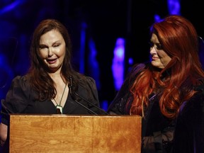 Ashley Judd, left, cries as she speaks while sister Wynonna Judd listens during the Country Music Hall of Fame Medallion Ceremony Sunday, May 1, 2022, in Nashville, Tenn.