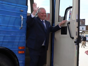 Ontario PC party leader Doug Ford waves from his bus as he arrives at the Federation of Northern Ontario Municipalities debate held at the Capitol Centre in North Bay, Ont. on Tuesday, May 10,2022.