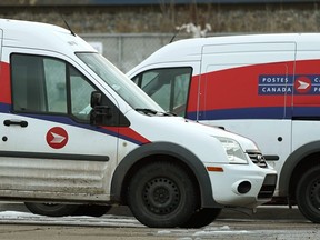 Canada Post vehicles parked at a postal delivery depot in southeast Edmonton on Thursday November 22, 2018.