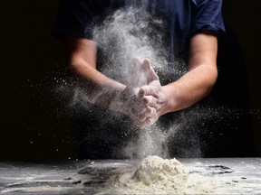Hand clap of chef with splash flour