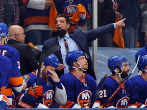 Assistant coach Lane Lambert handles the bench during the game against the Tampa Bay Lightning in Game Four of the Stanley Cup Semifinals during the 2021 Stanley Cup Playoffs at the Nassau Coliseum on June 19, 2021 in Uniondale, New York. The Islanders defeated the Lightning 3-2.
