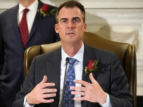 Oklahoma Gov. Kevin Stitt speaks at a signing ceremony to sign into law a bill, Tuesday, April 12, 2022, in Oklahoma City.