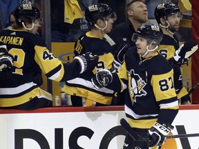 Penguins captain Sidney Crosby (87) celebrates his goal with the Pens bench against the Rangers during the first period in Game 4 of the first round of the 2022 Stanley Cup Playoffs at PPG Paints Arena in Pittsburgh, Monday, May 9, 2022.