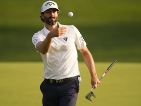 Adam Hadwin, of Canada, tosses his ball to his caddie on the 11th hole during the second round of the PGA Championship golf tournament at Southern Hills Country Club, Friday, May 20, 2022, in Tulsa, Okla.