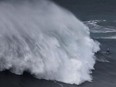 German surfer Sebastian Steudtner drops in on a large wave during the Nazare Tow Challenge at Praia do Norte in Nazare, Portugal February 11, 2020.